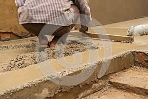 Indian labour leveling plasterred floor