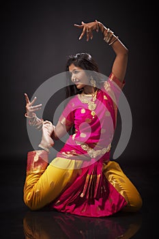 Indian lady performing traditional dance called Bharatnatyam