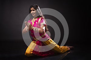 Indian lady performing traditional dance called Bharatnatyam