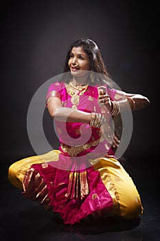 Indian lady performing traditional dance called Bharatnatyam photo