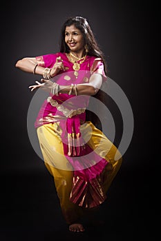 Indian lady performing traditional dance called Bharatnatyam photo