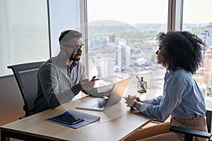 Indian latin hr manager on interview with African American applicant in office.