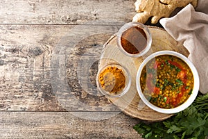 Indian lentil soup dal dhal in a bowl on wood