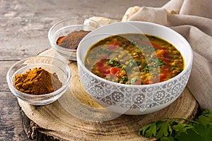 Indian lentil soup dal dhal in a bowl on wood