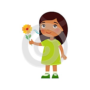 Indian little girl like the pleasant smell from a flower. Fragrance concept.