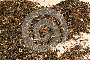 Indian loose Darjeeling black tea on jute burlap background, close up