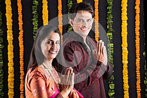 Indian maharashtrian young couple in traditional wear in namaskara pose