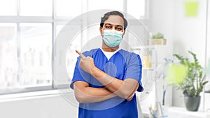 indian male doctor in blue uniform and mask