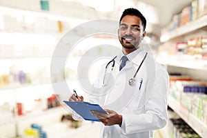Indian male doctor with clipboard and stethoscope