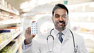 Indian male doctor or pharmacist with pills photo