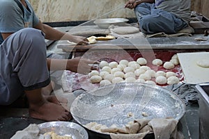 Indian males preparing naan