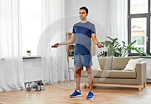 Indian man exercising with jump rope at home