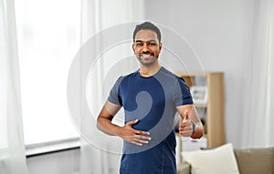 Indian man with fitness tracker showing thumbs up