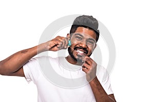 Indian Man flossing his teeth isolated on white background