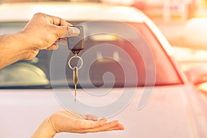 Indian man giving modern car keys ready for rental - Concept of