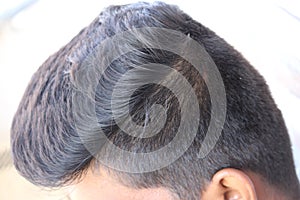 An indian man hair style in close up. Beautiful silky shine black hair, combed and cleanly manintained.