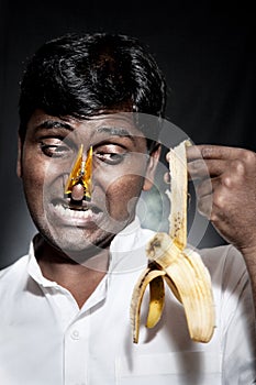 Indian man holding rotten banana