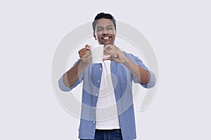 Indian Man Holding Tea Cup Showing Heart Gesture. Love Sign Coffee Cup. Man Tea or Coffee Lover Isolated