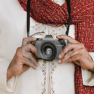 Indian man in a kurta with a digital camera