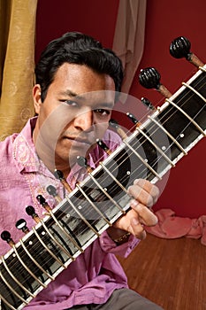 Indian Man Plays a Sitar