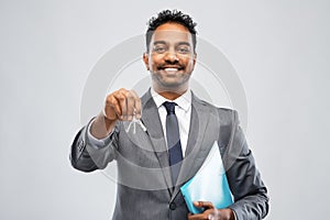 Indian man realtor with key and folder