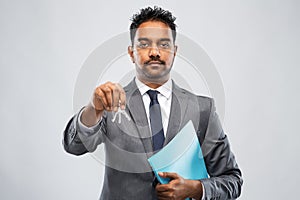 Indian man realtor with key and folder