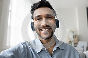 Indian man smile looking at smartphone camera make video call