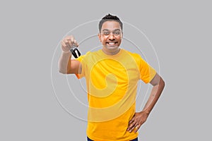 Indian Man Smilling Showing Car Keys Isolated. Driver