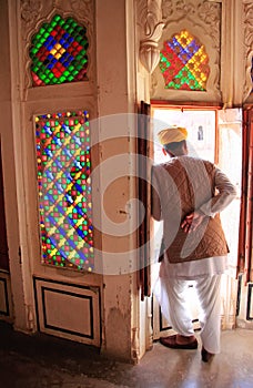 Indian man standing by the doorway at Mehrangarh Fort, Jodhpur,