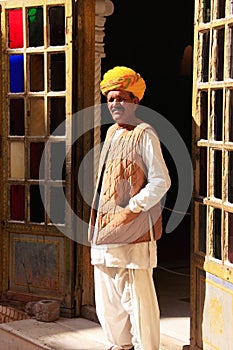 Indian man standing by the doorway at Mehrangarh Fort, Jodhpur,