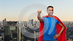 Indian man in superhero cape makes winning gesture