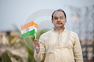 Indian man waving Indian Flags in air and celebrating Independence or Republic day
