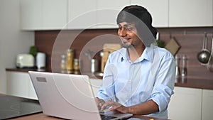indian man wearing talks online, using laptop computer for video connection