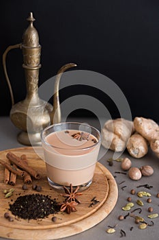 Indian masala tea with different spices and old jug