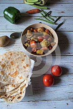 Indian meal aloo gobi or mixed vegetables and paratha or flat bread served and ready to eat.