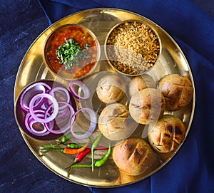 Indian meal in brass thaali -Dal baati churma