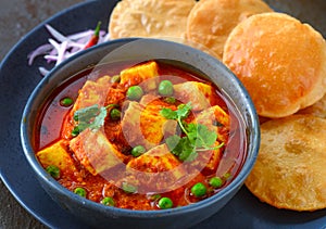 Indian meal matar paneer served with poori