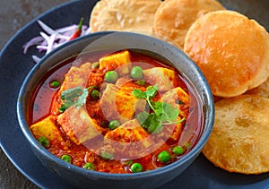 Indian meal matar paneer served with poori photo