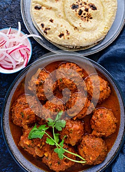 Indian meatballs or kofta served with flatbreadand pickled onion