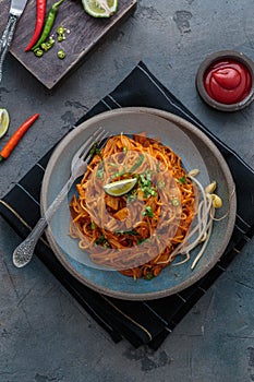 Indian mee goreng or mee goreng mamak, Indonesian and Malaysian cuisine, spicy fried noodles in a plate, top view