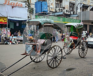 Indian men with rickshaws on street in Kolkata, India