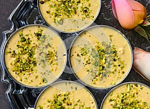 Kesar pista basundi or punjabi phirni served in silver tray photo