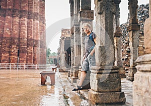 Indian moon season - young tourist man waits intense rain in Qutb Minar, New Delhi