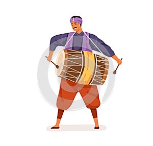 Indian musician playing big dholak drum with sticks. Happy man performing ethnic folk music on traditional instrument of photo