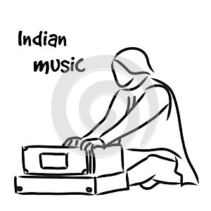 Indian musician playing harmonium