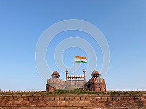 Indian national flag flying on iconic Red fort at Delhi.