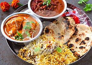 Indian non-vegetarian Meal -Butter Chicken, rajma, biryani with roti and salad