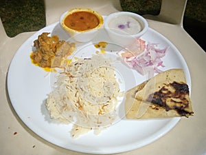 Indian Nonveg Thali rice,meet, roti,Carri and onion..