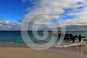 Indian ocean, sky and emerald green ocean with old jetty