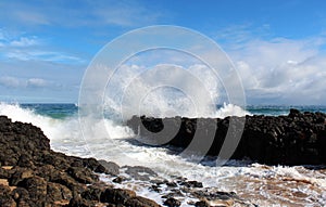 Indian Ocean waves dumping against dark basalt rocks on Ocean Beach Bunbury Western Australia photo